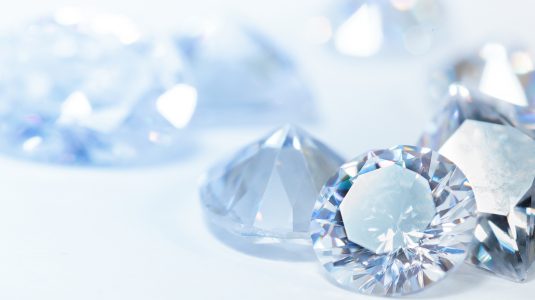 Shiny white blue diamonds on dark background